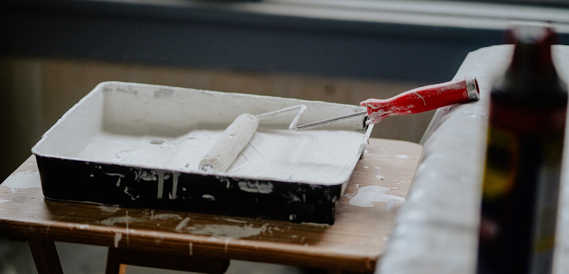 Paint palette with roller and white paint