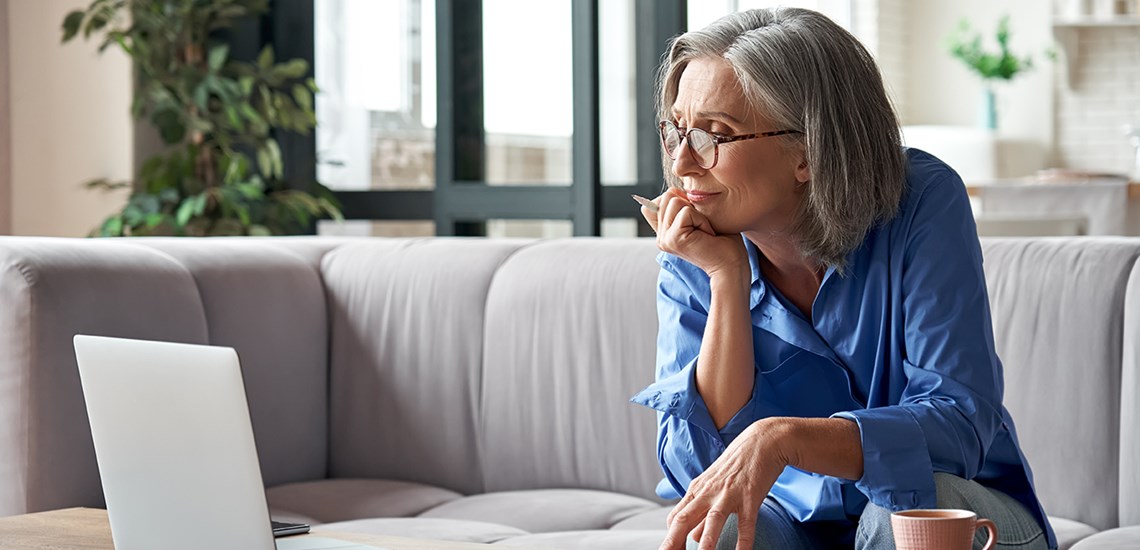 Woman looking at laptop reviewing her options