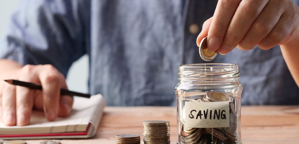 person saving money in money pot savings coins ISA